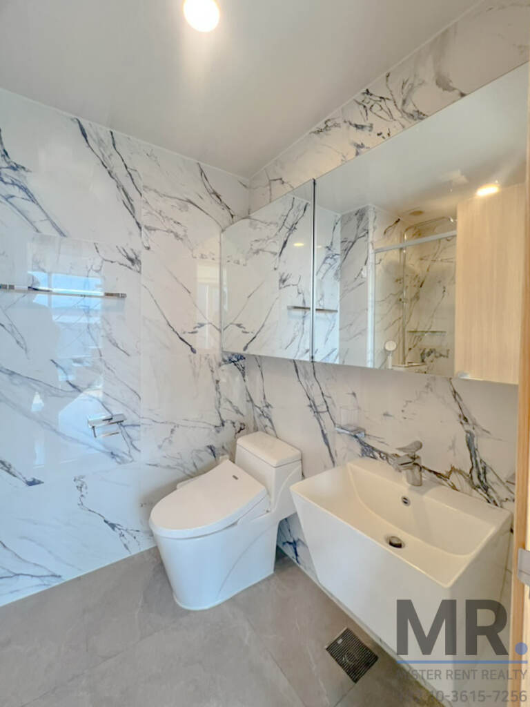 Bathroom with marble walls, mirror cabinet and square sink