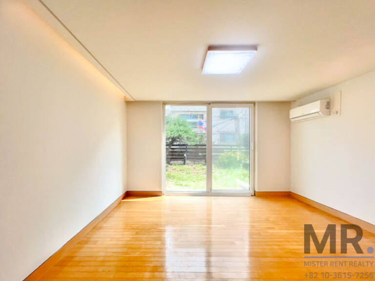 Living area with wood floor and glass door onto the garden