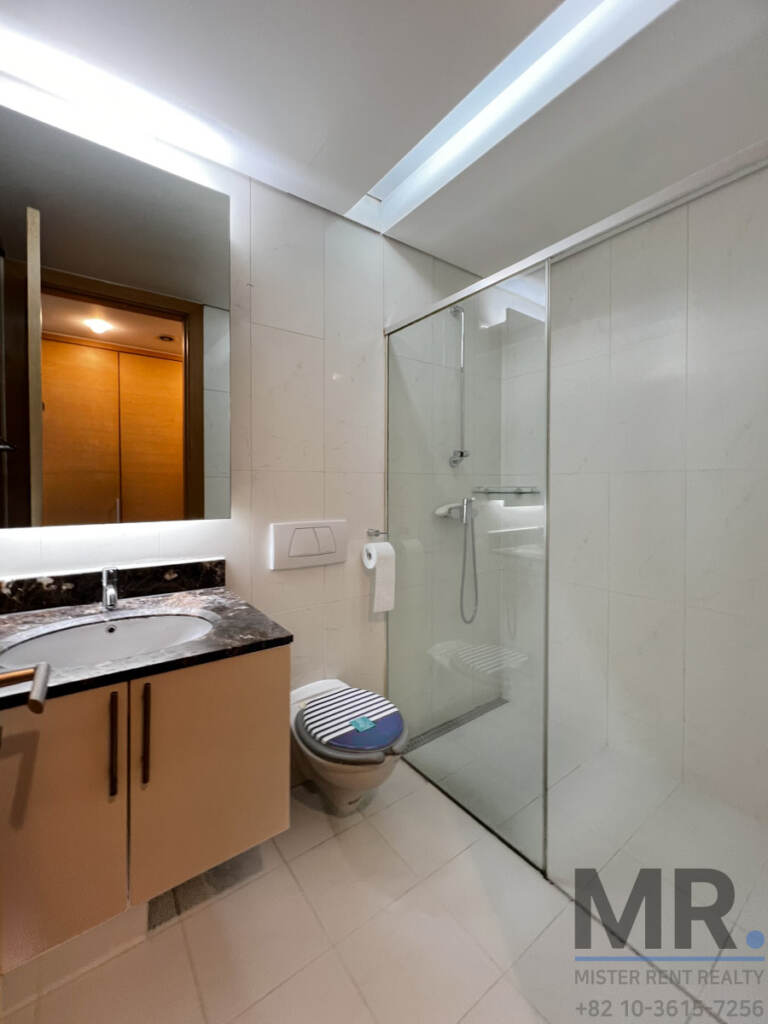 Bathroom with granite vanity and glass shower