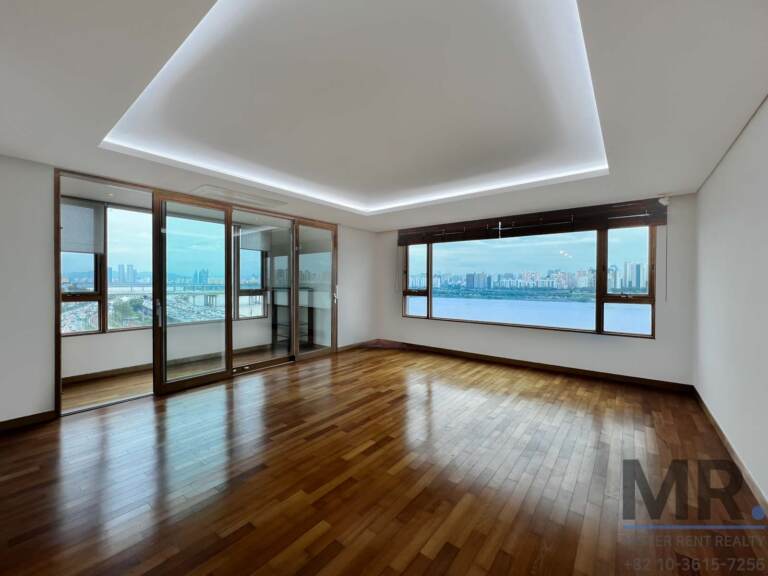 Bright room with recessed ceiling light and river-view picture window