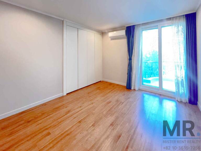 Bedroom with full-height wardrobe and glass door to the balcony