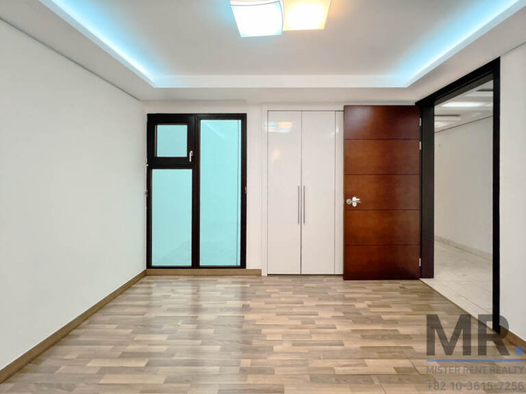 Small room with built-in wardrobe and glass door to the balcony