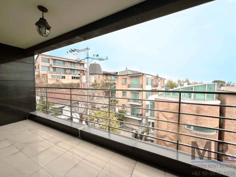 Terrace with stone-tile floor overlooking brick houses
