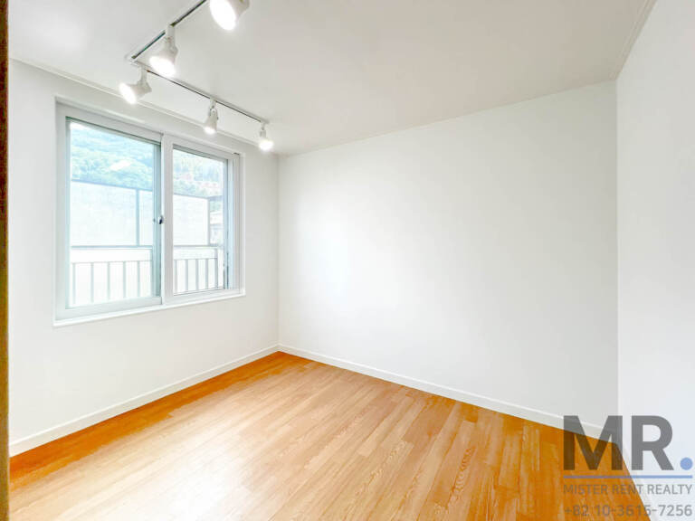 Room with track lighting and window