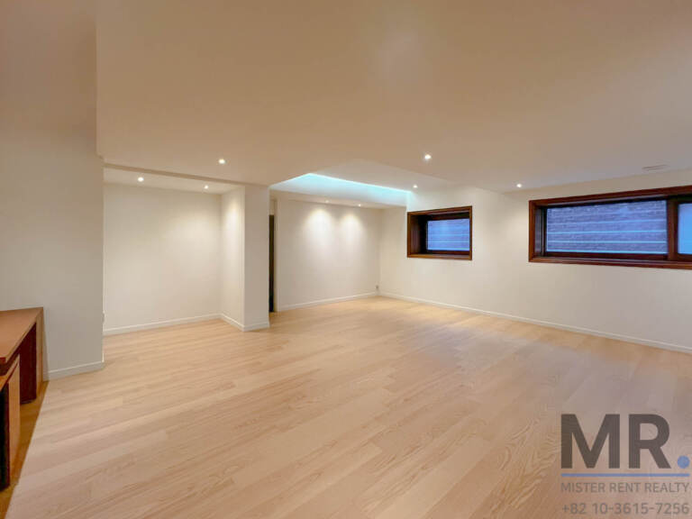 Basement family room with recessed lighting and high windows