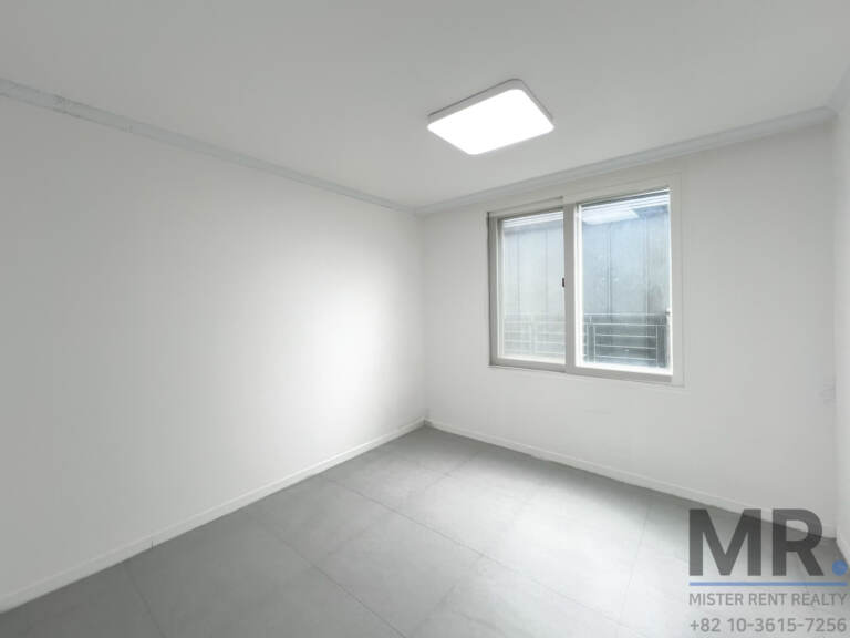 Bedroom with gray floor tiles and frosted window