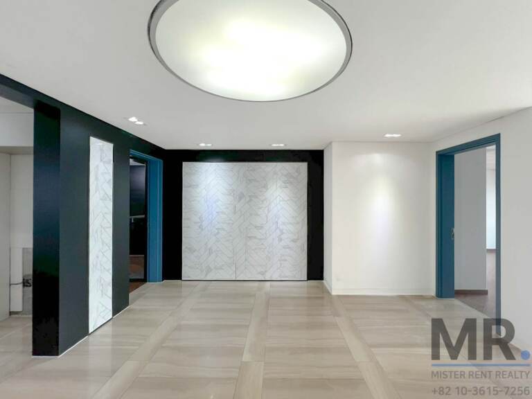 Entrance hall with herringbone marble feature wall and teal door frames