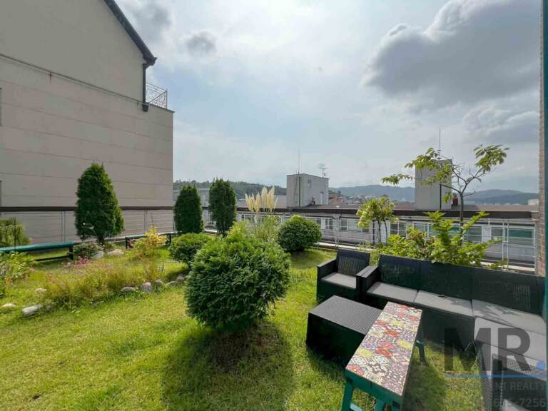 Outdoor rattan sofa set on the rooftop garden with mountain view