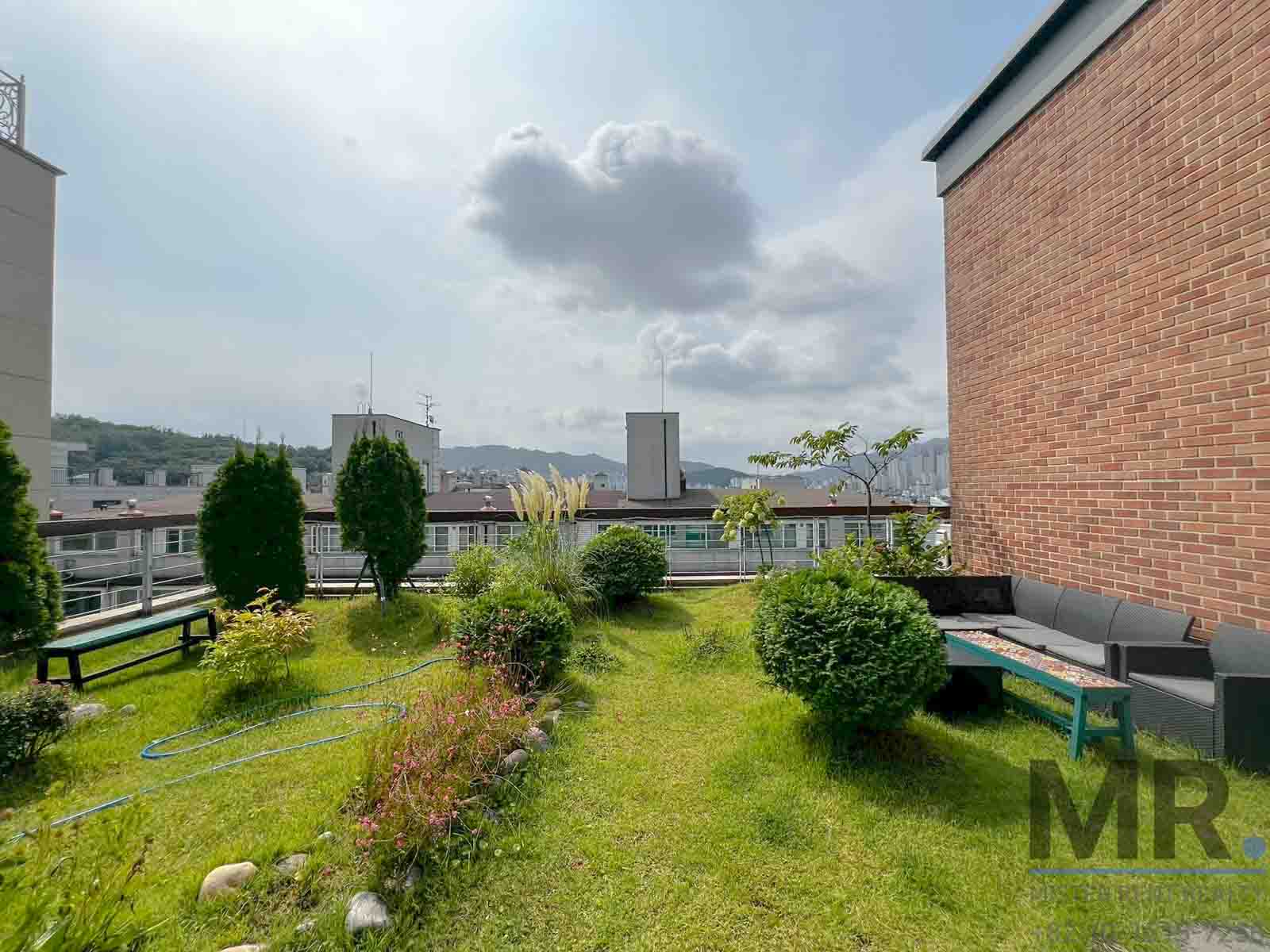 Lush rooftop garden with seating area