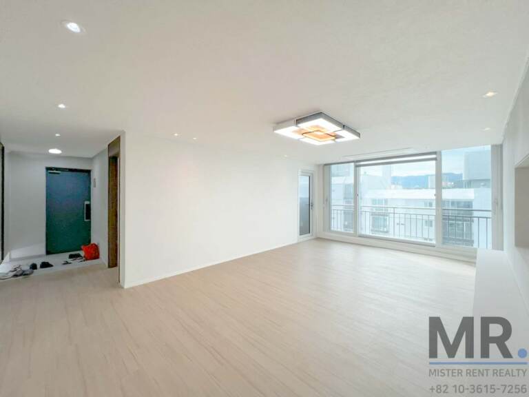 Living room with entrance view and large balcony window