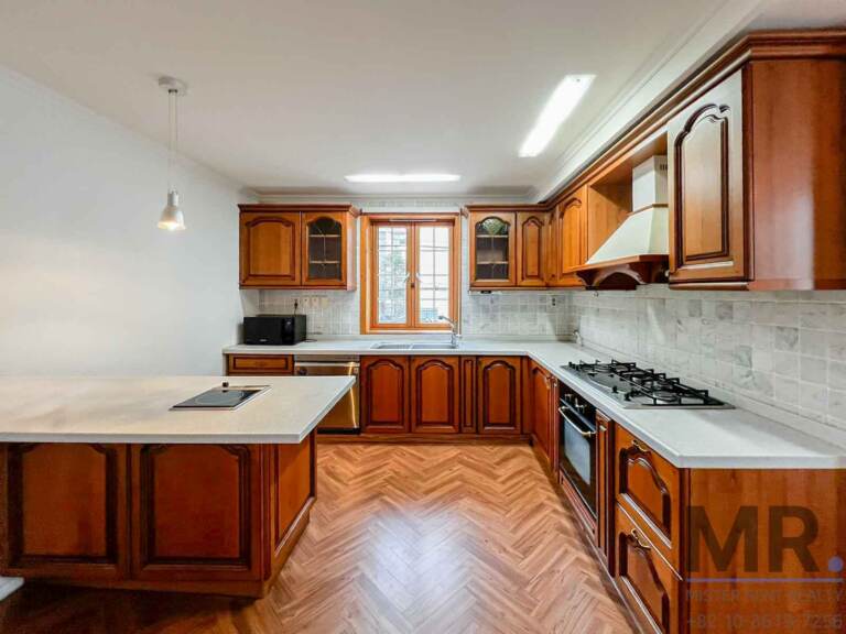 Classic kitchen with cherry wood cabinets, gas range and island