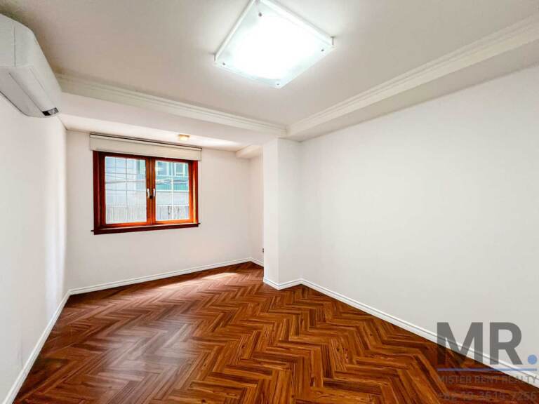 Bedroom with crown molding and wooden window
