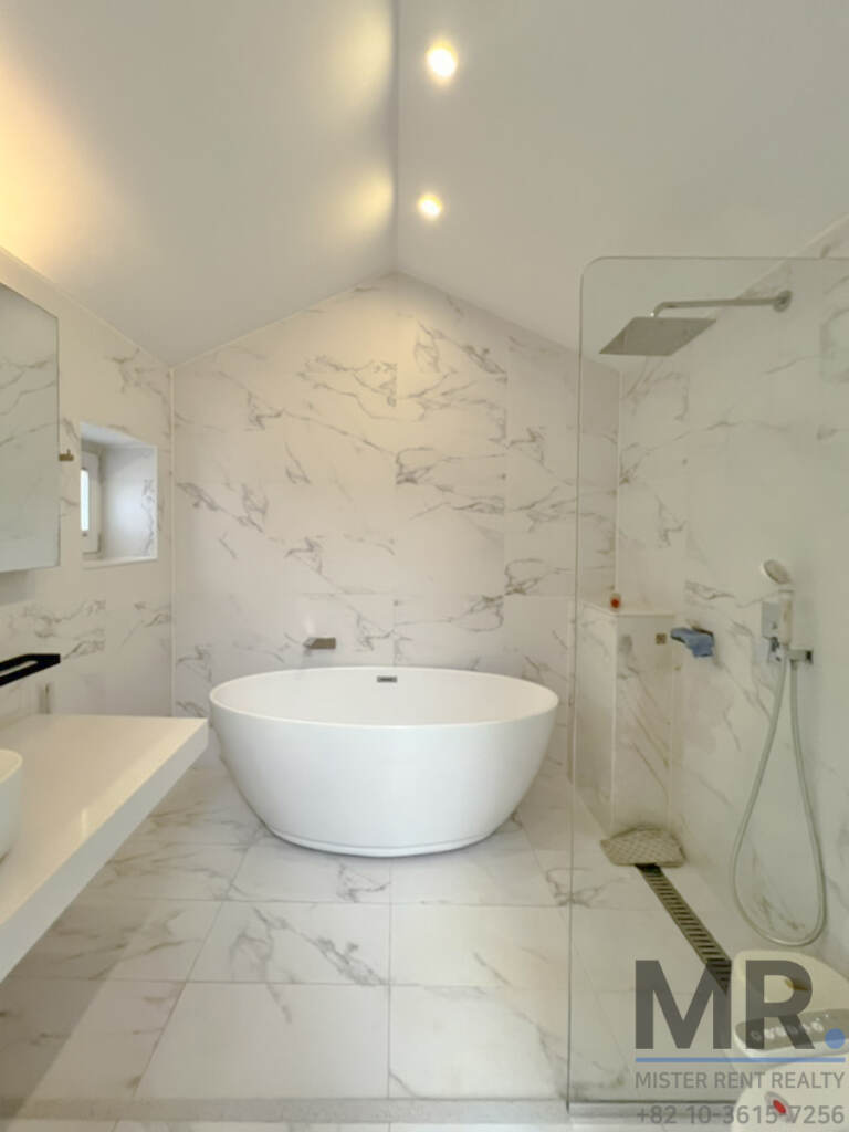 Marble bathroom with freestanding bathtub and rain shower