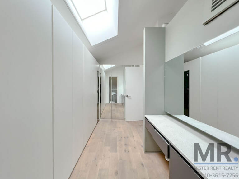 Dressing area with skylight, built-in wardrobes and vanity counter