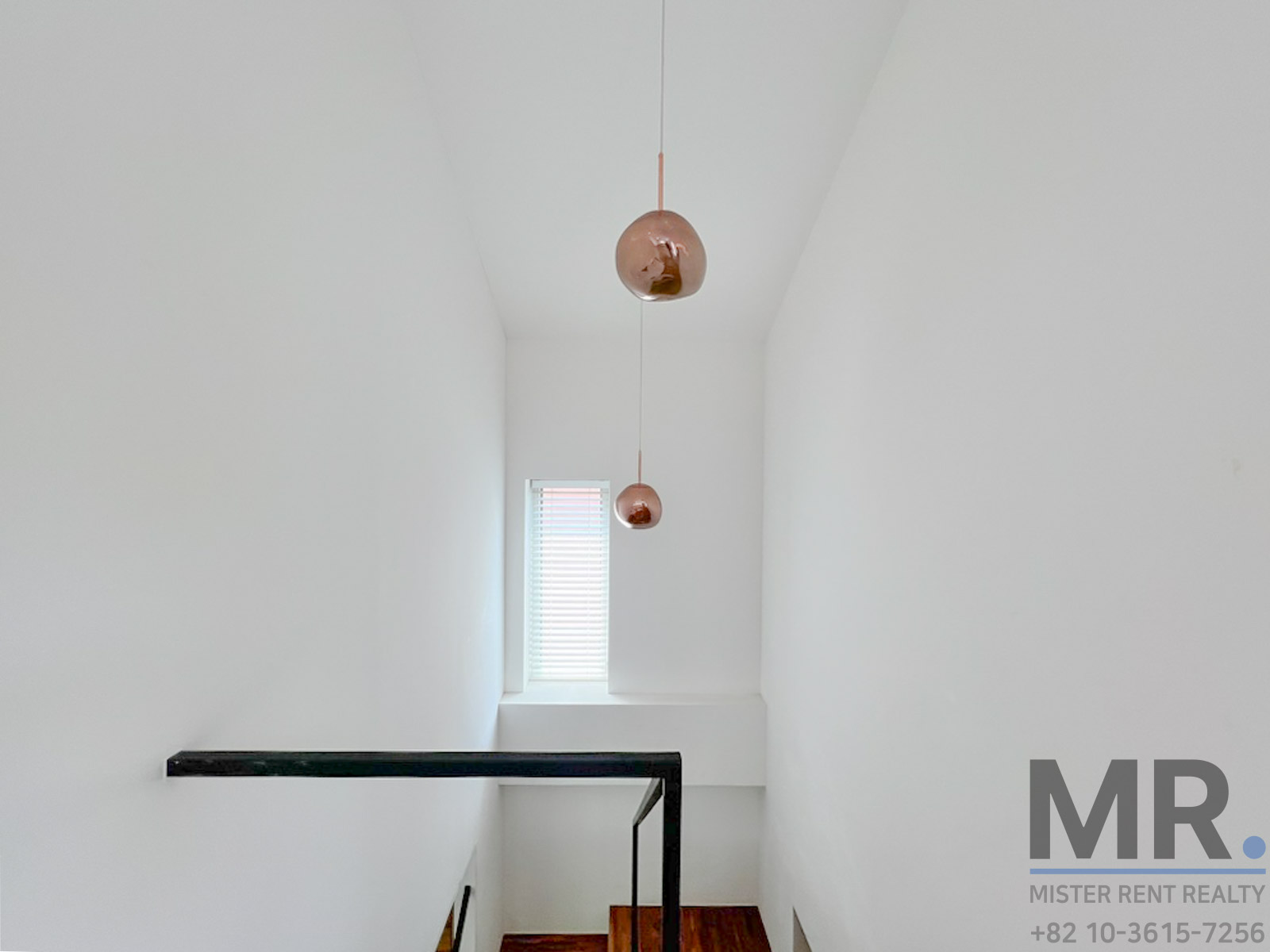 Minimalist staircase with pendant lights.