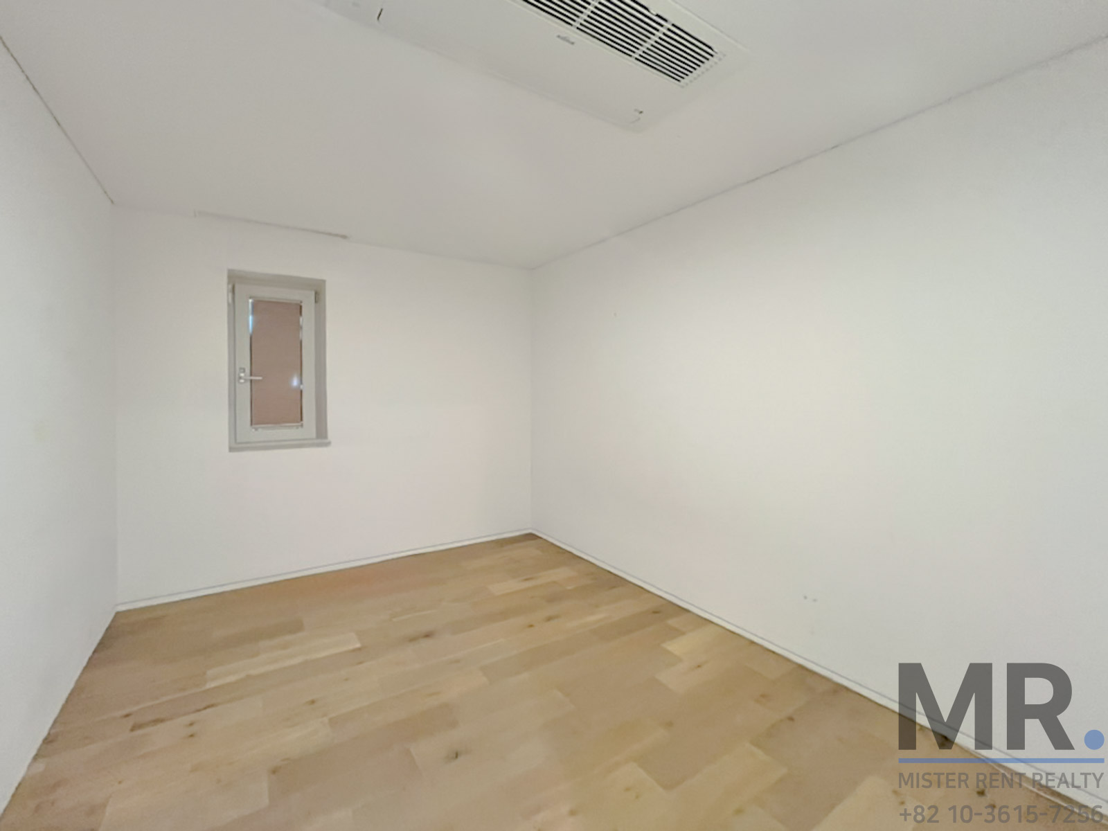 Empty room with wooden flooring.