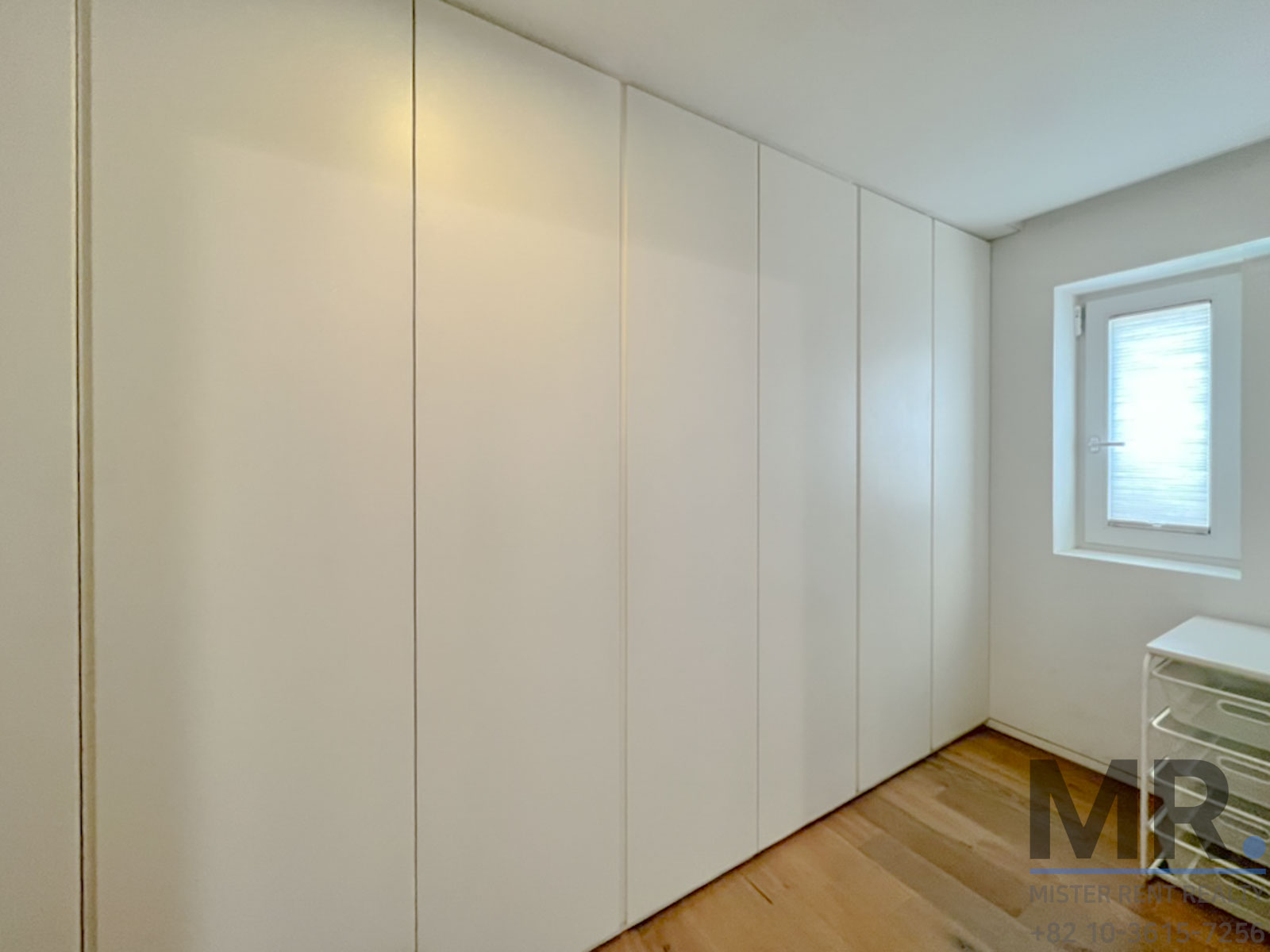 Minimalist white closet in bright room