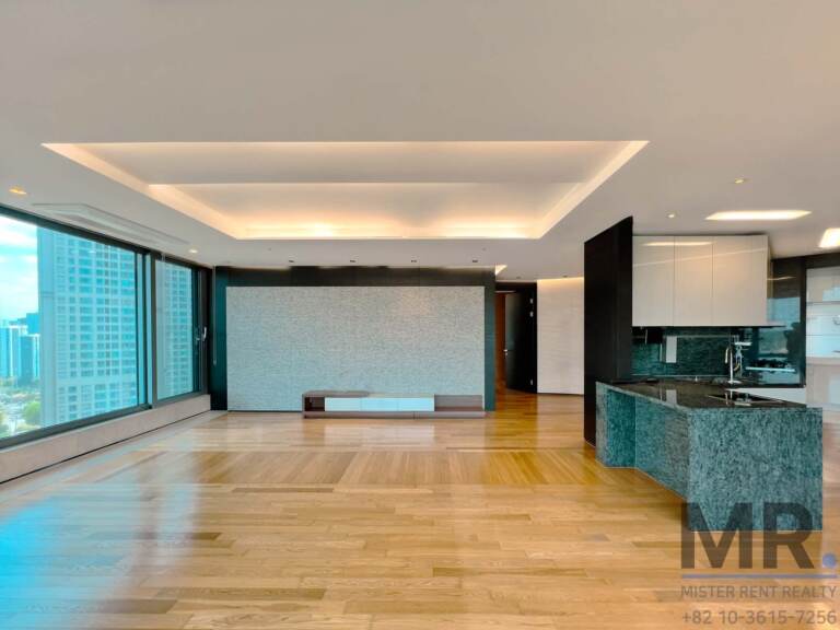 Open living and kitchen space with granite island and large windows
