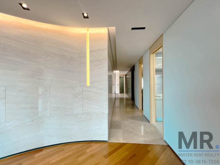 Entrance hallway with curved marble wall and vertical light strip