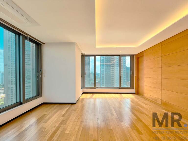 Corner living area with floor-to-ceiling windows, wood-panel wall and high-rise view