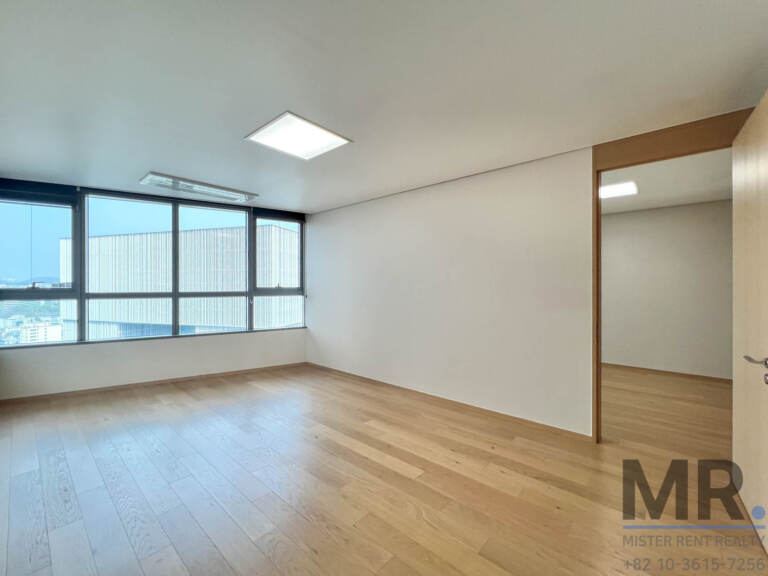 Bedroom with wide window and light oak floor
