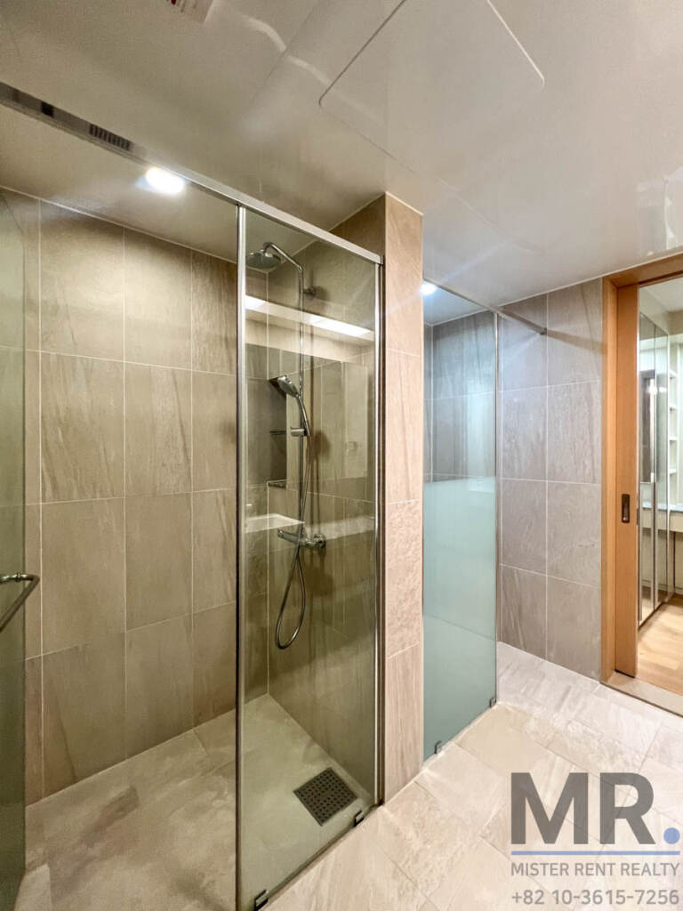 Bathroom with glass shower and grey stone tiles