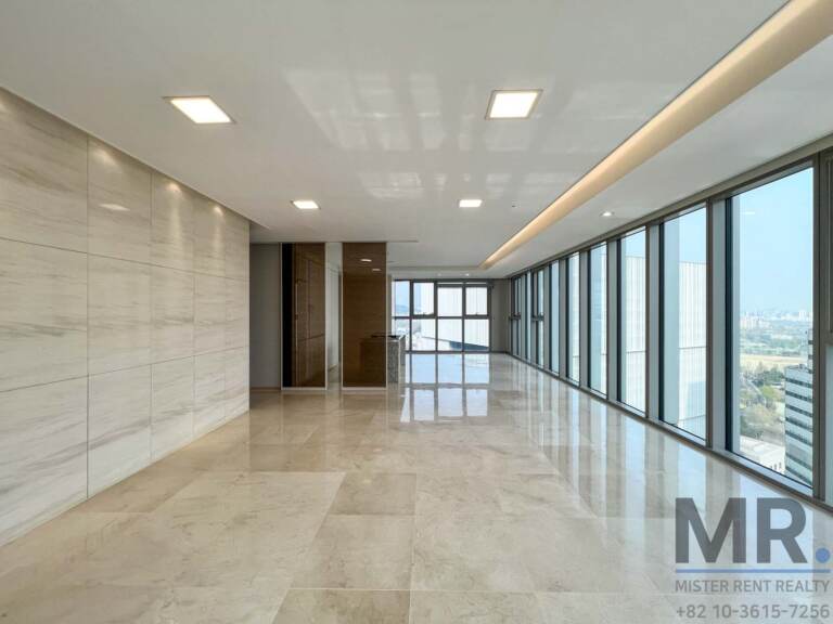 Wide living room with recessed lighting and a long row of windows