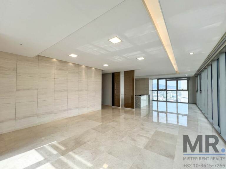 Bright living area with stone-panel feature wall and sunlit marble floor