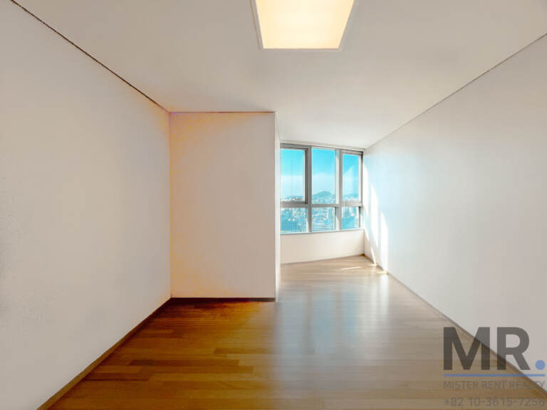 Narrow room with oak floor and window at the end