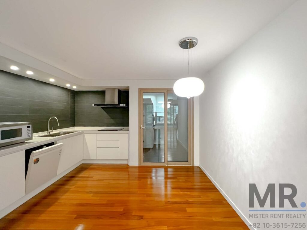 Modern kitchen with wooden flooring.