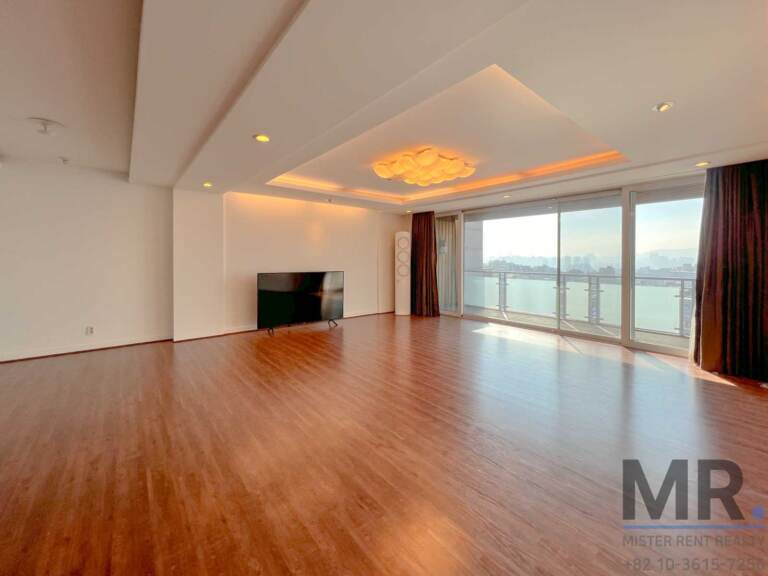Sunny living room with sliding doors to the balcony and city view