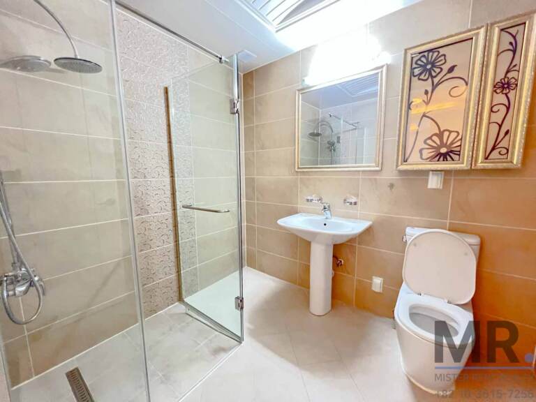 Bathroom with glass shower, pedestal sink and floral wall panels