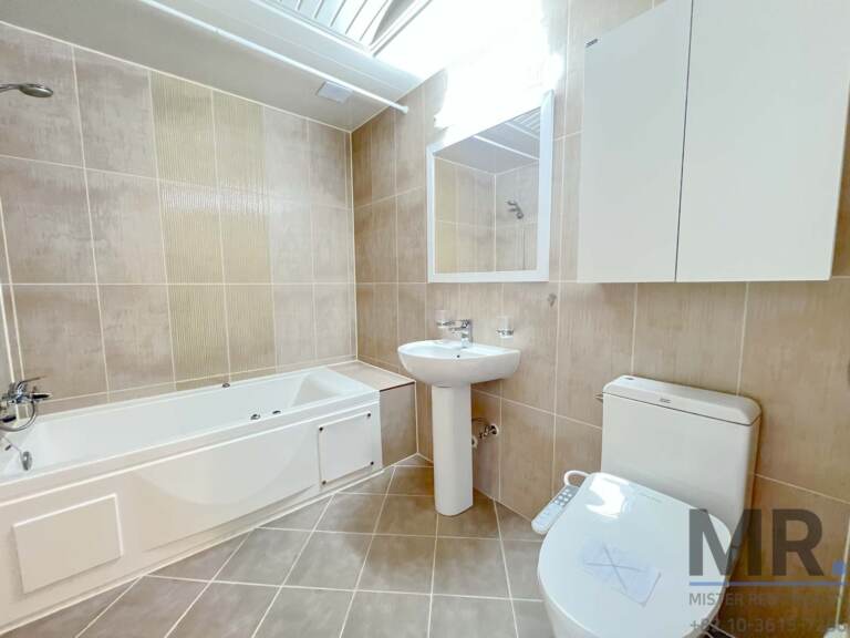 Bathroom with jacuzzi bathtub, pedestal sink and skylight