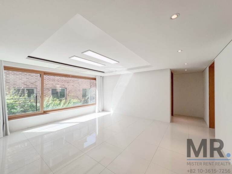 Living area with recessed ceiling lights and wood-framed window