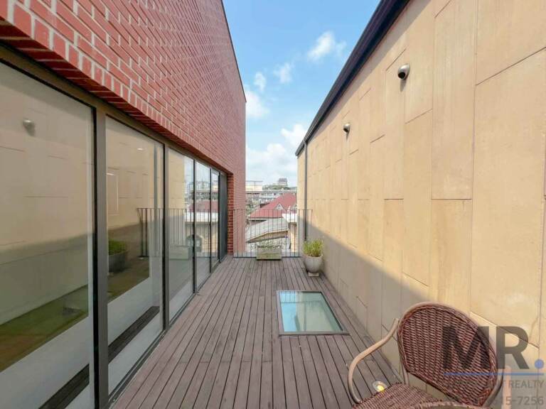 Terrace with skylight panel in the deck and rattan chair