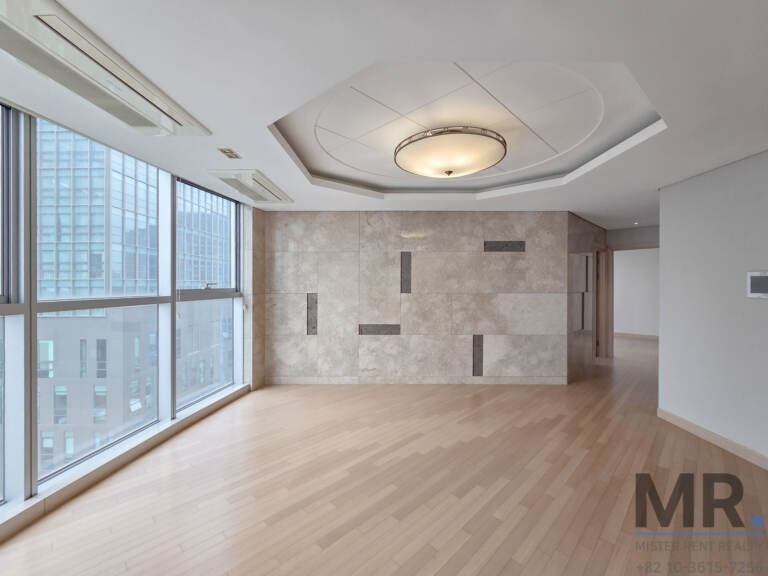 Living room with stone feature wall and floor-to-ceiling windows