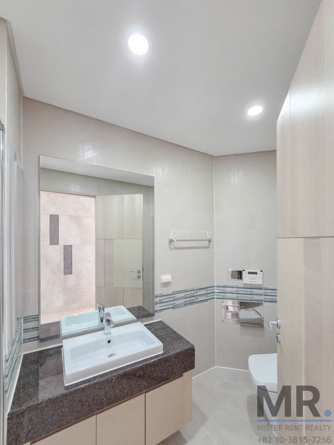 Bathroom with granite vanity and large mirror