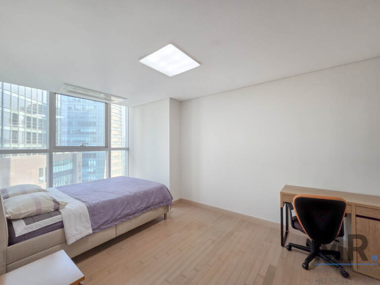 Bedroom with single bed and study desk by the window