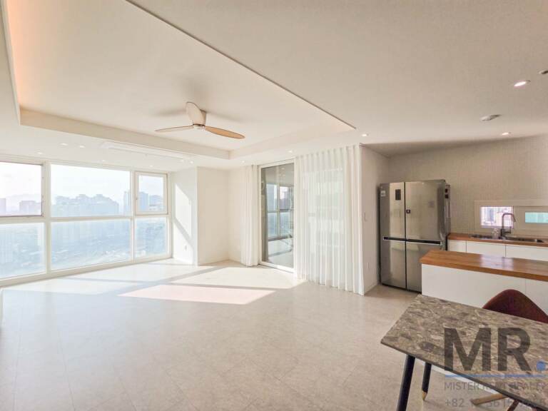 Living room with panoramic corner windows and kitchen counter