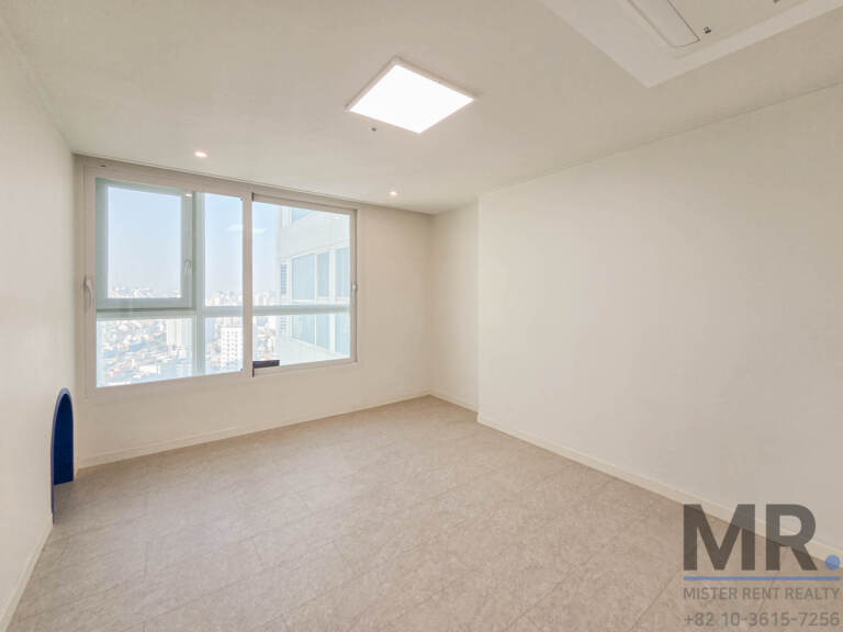 Bright bedroom with large window overlooking the city
