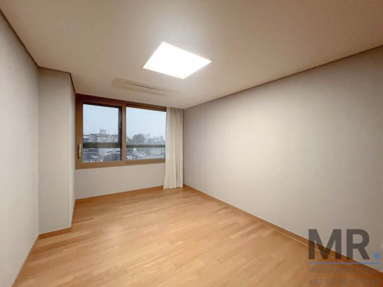 Empty bedroom with window and sheer curtain