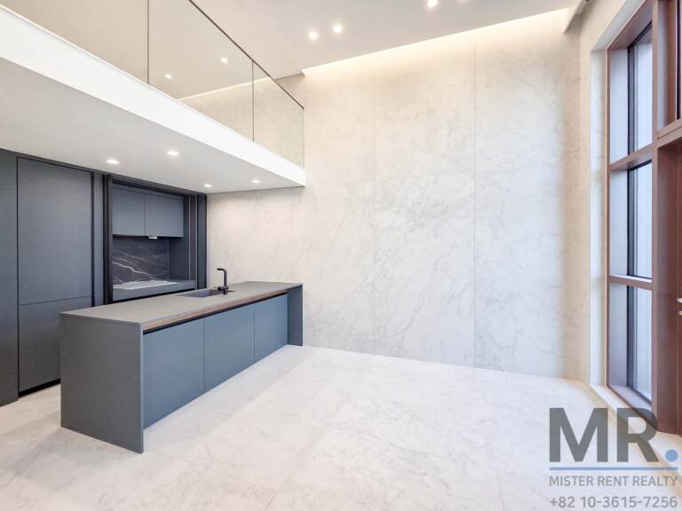 Gray kitchen with long island and marble-look wall panels