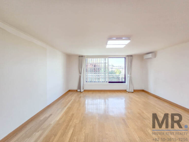 Bedroom with glossy oak floor and window onto the balcony