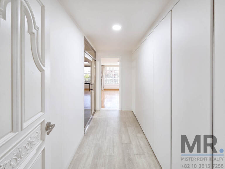 Hallway lined with floor-to-ceiling built-in closets