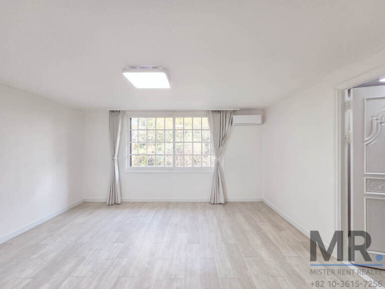 Bedroom with light wood floor, curtained grid window and air conditioner