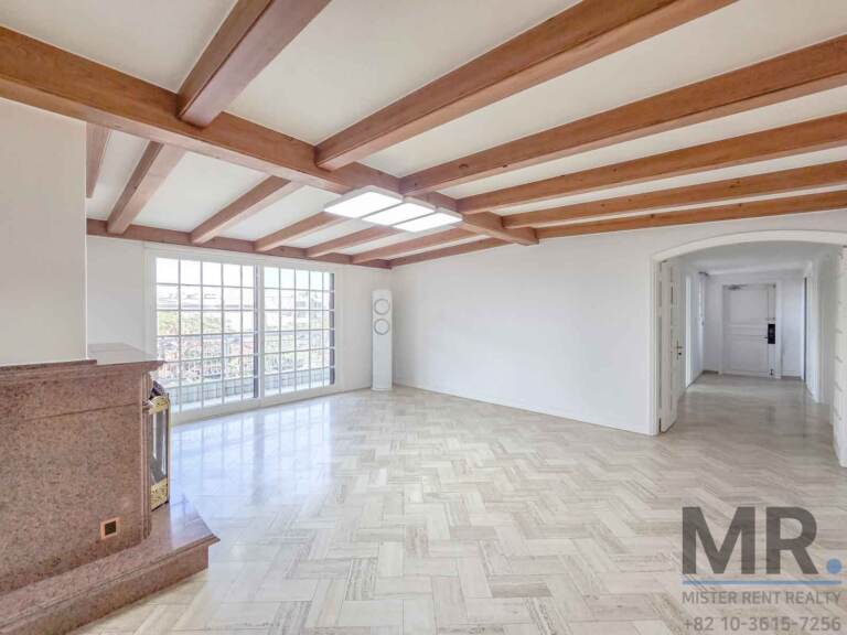 Living room corner with fireplace, arched doorway and hallway view