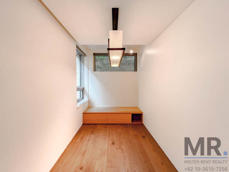 Study nook with built-in wooden bench and pendant light